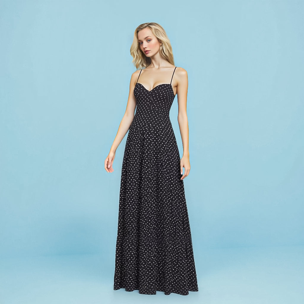 Model wearing the Shopise Sabine Polka Dot Maxi Dress in black with white dots, featuring a sweetheart neckline and full-length flared skirt